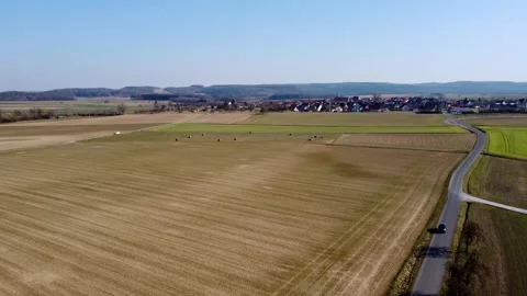 Plowed fields near the road and the village Stock Footage 172058171