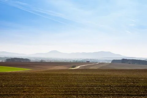 Plowed fields under blue sky Stock Photos