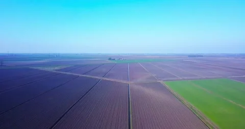 Plowed unseeded fields near terrain plot with early sprouts Stock Footage 150587265