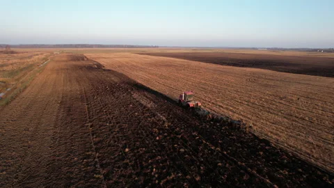 Plowing field on Tractor, drone view. Cultivated land and soil tillage. 動画素材 169225351