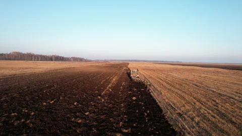 Plowing field on Tractor, drone view. Cultivated land and soil tillage. Stock Footage 169225611
