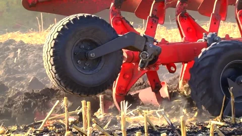Plowing in the field by a tractor with a trailed unit Stock Footage 145943688