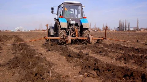 Plowing fields with a tractor. Cultivation of soil Stock Footage 73497281