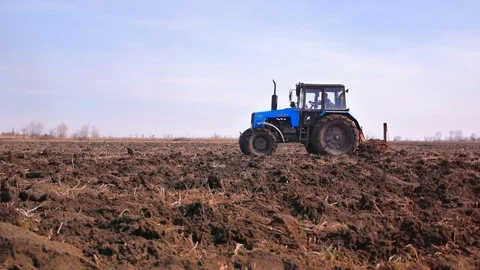 Plowing fields with a tractor. Cultivation of soil Stock Footage 73497302