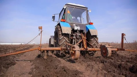Plowing fields with a tractor. Cultivation of soil Stock Footage 73497318