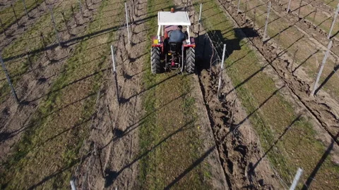 Plowing harrowing between rows of vineyard Stock Footage 151553662