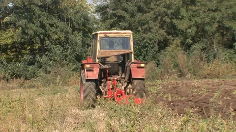 Plowing the land with a red tractor Stock Footage 35451823