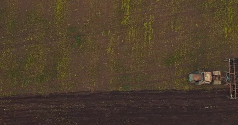 Plowing machine is processing land in spring or summer, view from top 動画素材 197700317