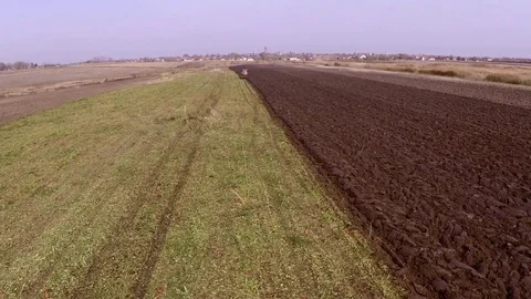 Plowing of paprika field on cloudy fall day. Aerial footage. Stock Footage 84184819