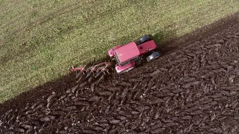 Plowing of paprika field on cloudy fall day. Aerial footage. Stock Footage 84185997