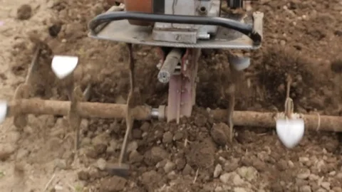 Plowing the soil with a motoblock Stock Footage 76366397