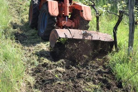 Plowing of the soil with old rotary hoe 스톡 사진