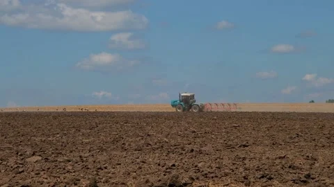 Plowing with a tractor with a plow in the field Stock Footage 166946557