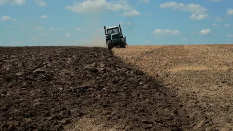 Plowing with a tractor with a plow in the field Video stock 166946561