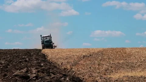 Plowing with a tractor with a plow in the field Video stock 166946562