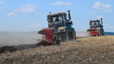Plowing with a tractor with a plow in the field Video stock 166946606