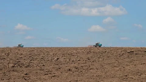 Plowing with a tractor with a plow in the field Stock Footage 166947059