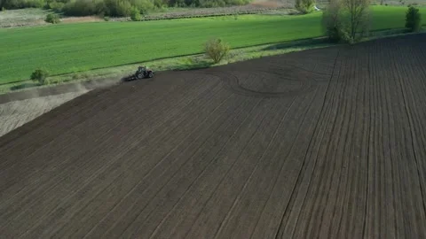 Plowing tractor turning at the field edge Stock Footage 130553509