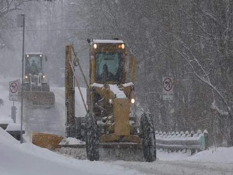 Plows clear a snow covered road Stock Footage 77534561