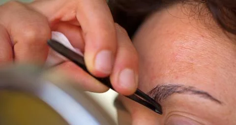 Plucking eyebrows Stock Photos