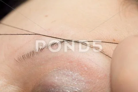 Plucking eyebrows thread Stock Photos