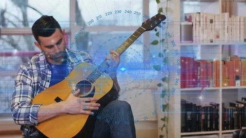 Plucking strings to tune, seated man practicing chords for music tutorial with Vídeos de archivo 332468846