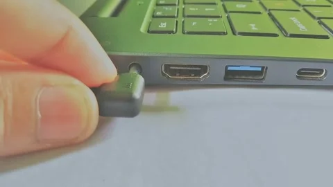 Plug in adapter cable to laptop electronic device Stock Footage 295747121