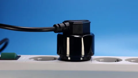 Plug With Adapter In The Socket Of An Electric Extension Cord On Blue Background 스톡 동영상 244939239