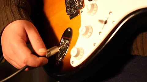 Plug In and Out Cable on Guitar Stock Footage 46124066