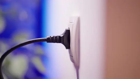 Plug in and plug out of electric outlet thick black cable close-up 4K Stock Footage 172571060