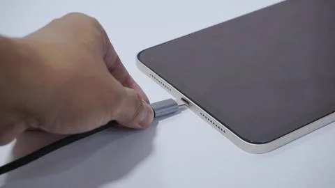 Plug in the charger of Gadget with a Type-C Cable, Isolated background footage Stock Photos