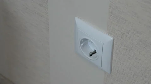 Plug the charger into a power outlet Stock-Footage 115372490