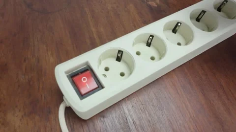 Plug in charging adapter into Switching On/Off Power Strip Stock Footage 311794491