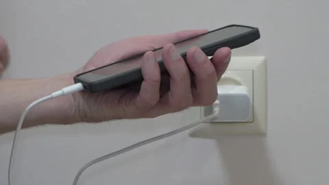 Plug  the charging cable to the smartphone Stock-Footage 301431832