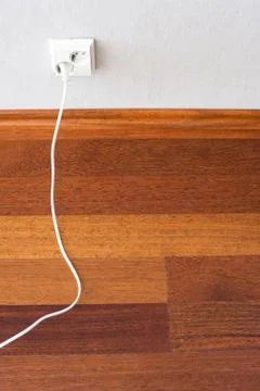 Plug connected to the outlet in a wall Stock Photos