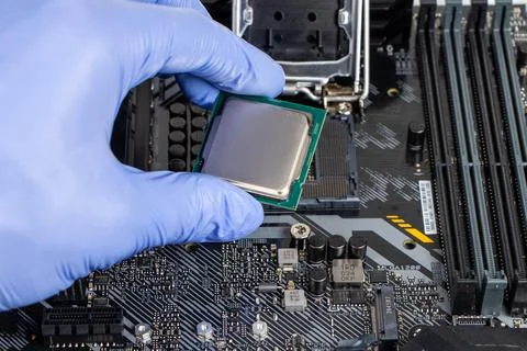 Plug in CPU microprocessor to motherboard socket. Technological background. C Stock-Fotos