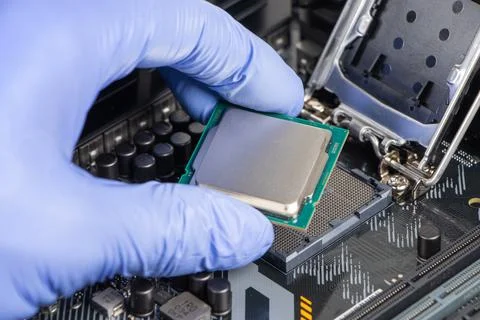 Plug in CPU microprocessor to motherboard socket. Technological background. C 写真素材
