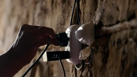 Plug the device into the power Stock Footage 332047854