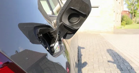 Plug in electric car to charge Stock Footage 129430225