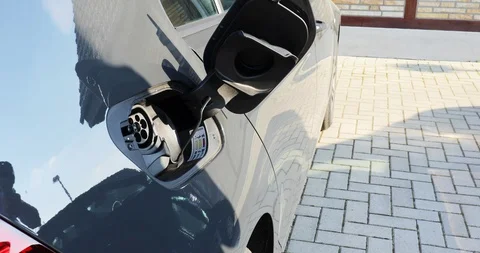 Plug in electric car to charge Stock Footage 129430230