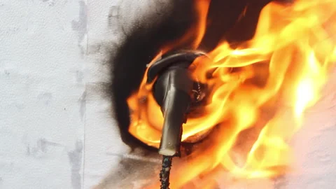 The plug from the electrical appliance inserted into the socket burns and melts  Stock Footage 154116830
