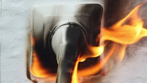 The plug from the electrical appliance inserted into the socket burns and melts  Video stock 154117122