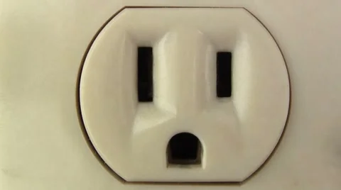 Plug in electronic into outlet macro Stock Footage