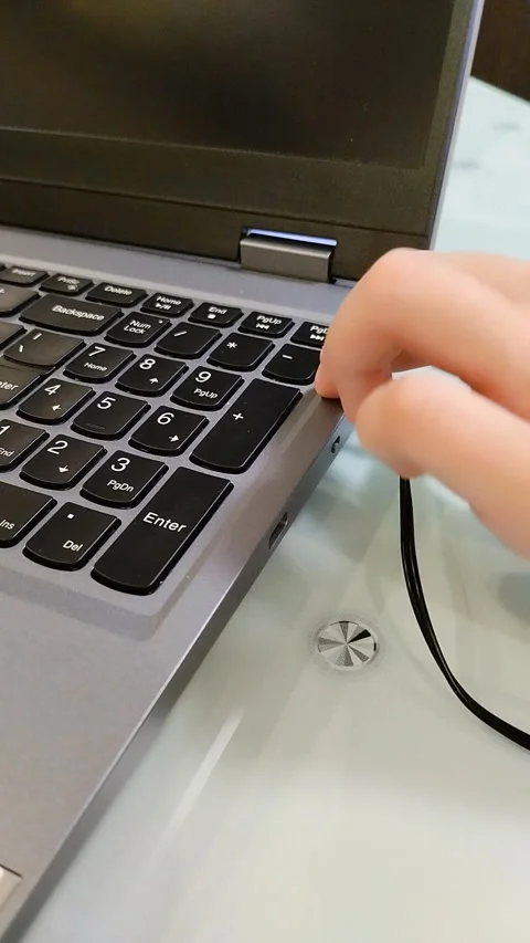 Plug headphones into the laptop's headphone jack Video stock 331148573