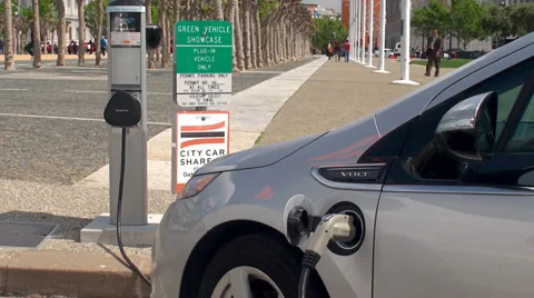Plug-in hybrid electric vehicle is recharging at EV charging station. Stock Footage