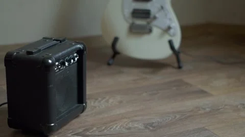 Plug in jack cable to the mini guitar amplifier Stock Footage