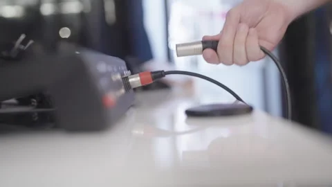 Plug in multi cables into audio mixer close-up 4K Stock Footage 280553183