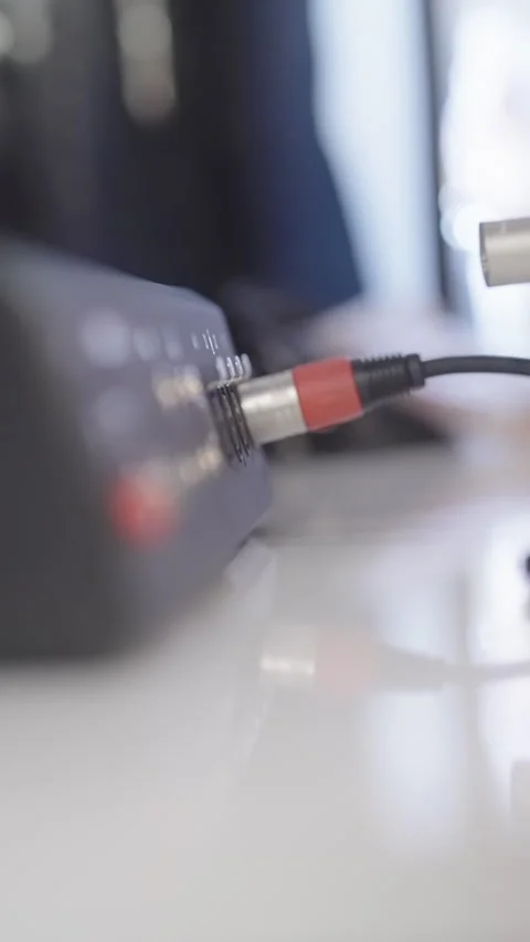 Plug in multi cables into audio mixer close-up Stock Footage 324136382