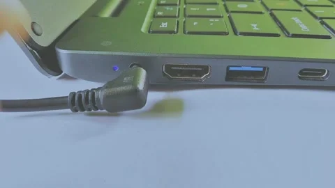 Plug out adapter cable from laptop electronic device Stock Footage 295747120