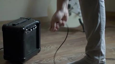 Plug out jack cable from the mini guitar amplifier Stock Footage